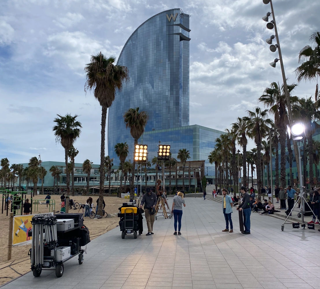DotFive crew setting up lights on the Barcelona seafront, with the W Hotel behind