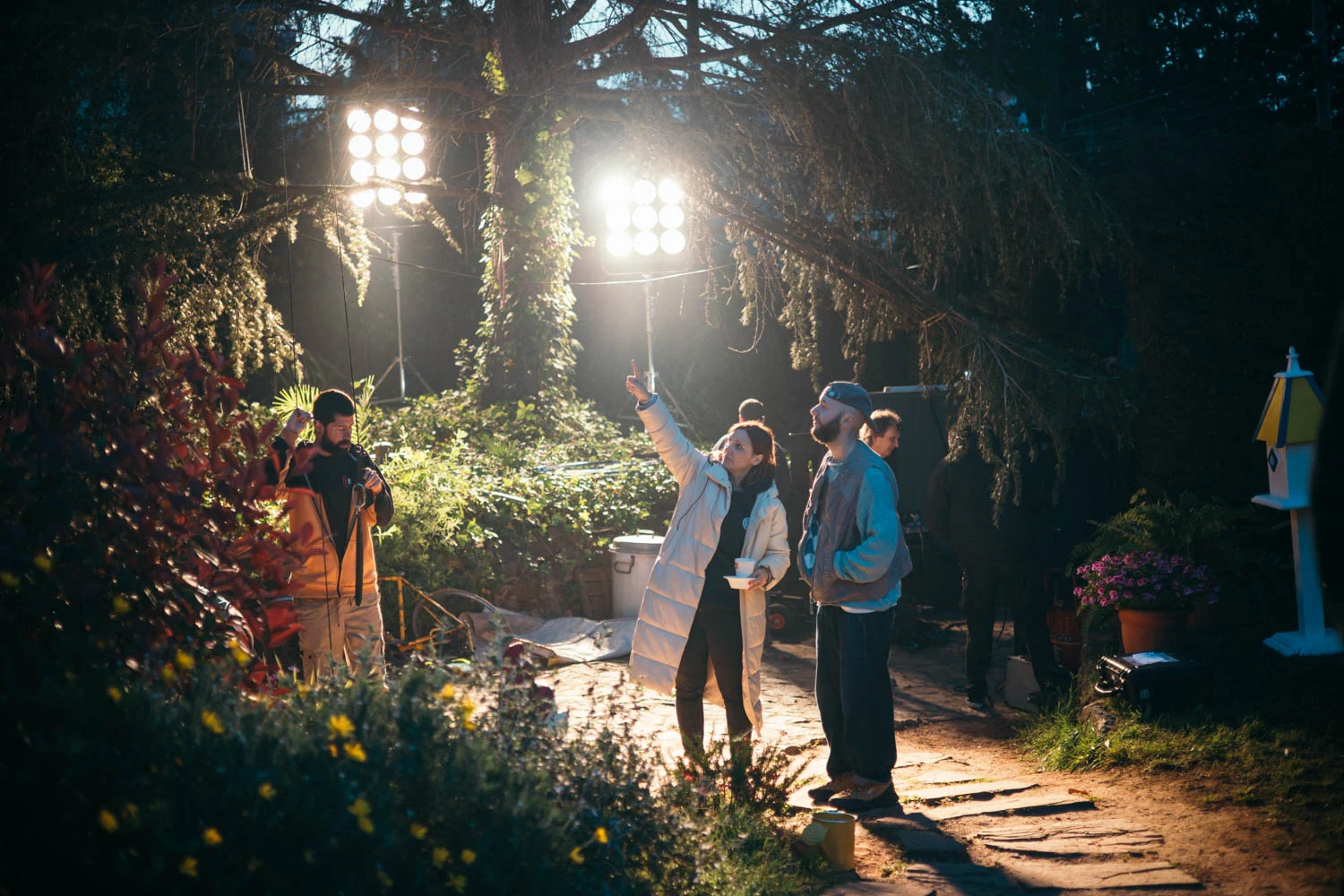 Glassy Films crew lighting a night shoot in a lush garden