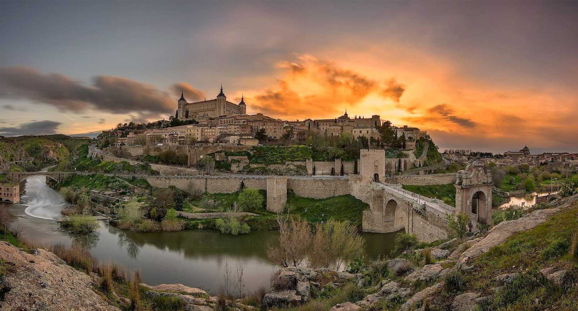 Toledo at sunset, with the Alcázar and the Alcántara bridge over the Tagus