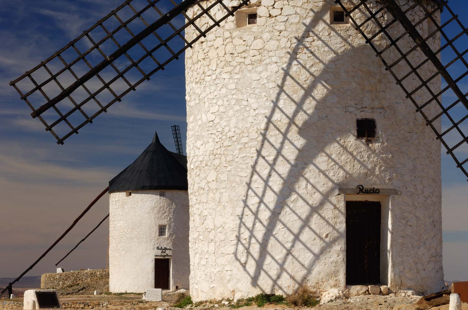White windmills of Consuegra, in La Mancha, against a blue sky